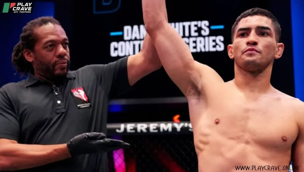 An MMA fighter raising his hand after winning the UFC fight
