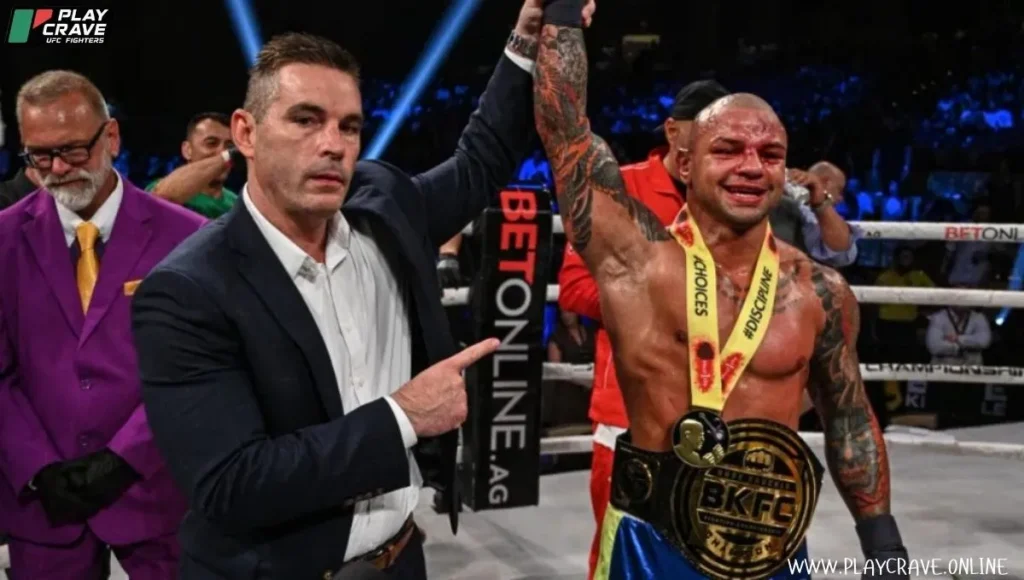 Thiago with BKFC belt around his stomach after winning the final round
