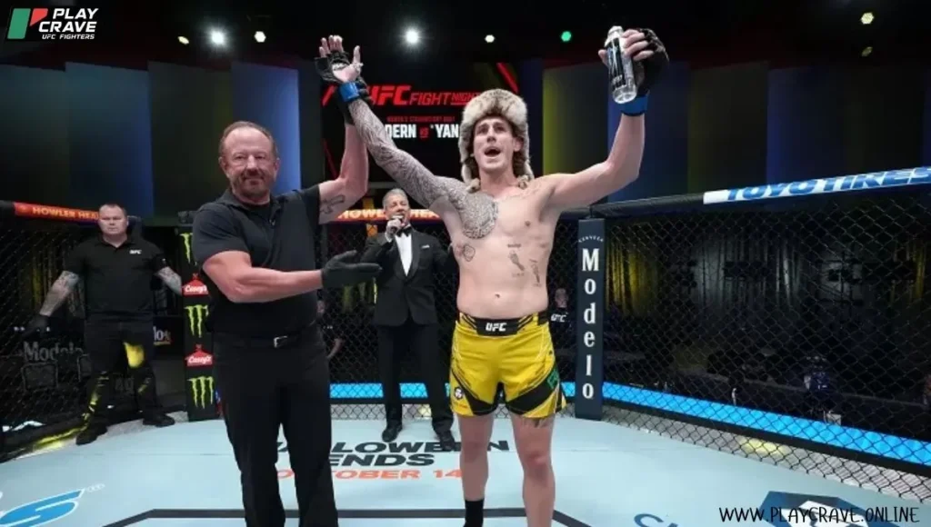 A UFC fighter raising his both hands after winning the fight
