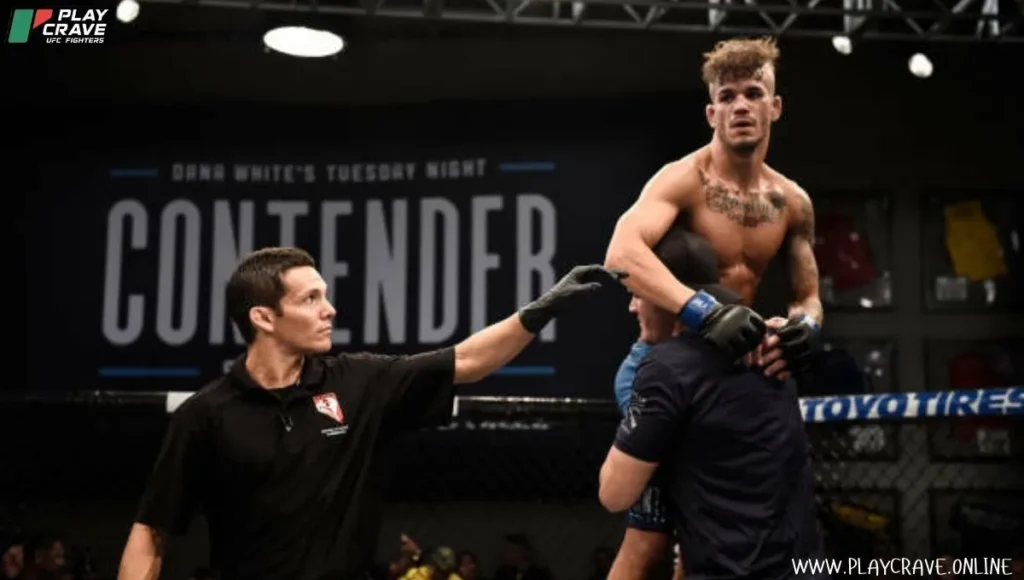 A MMA fighter picked up by his teammate after winning the match